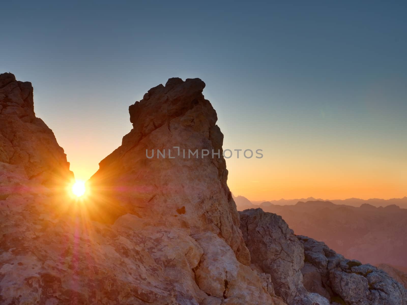 Morning sun between shar rocks,  Alpine  cliff above valley. Daybreak Sun  by rdonar2