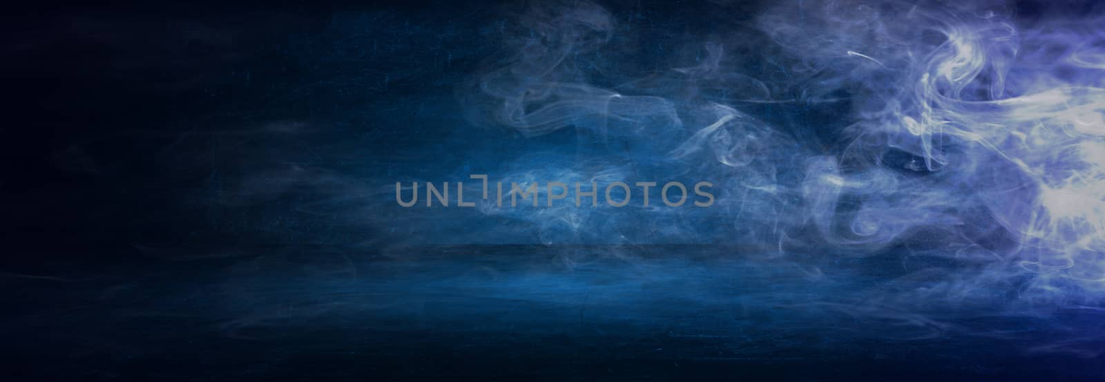 dark blue cement wall studio background with mist or fog, colorful smoke backdrop 