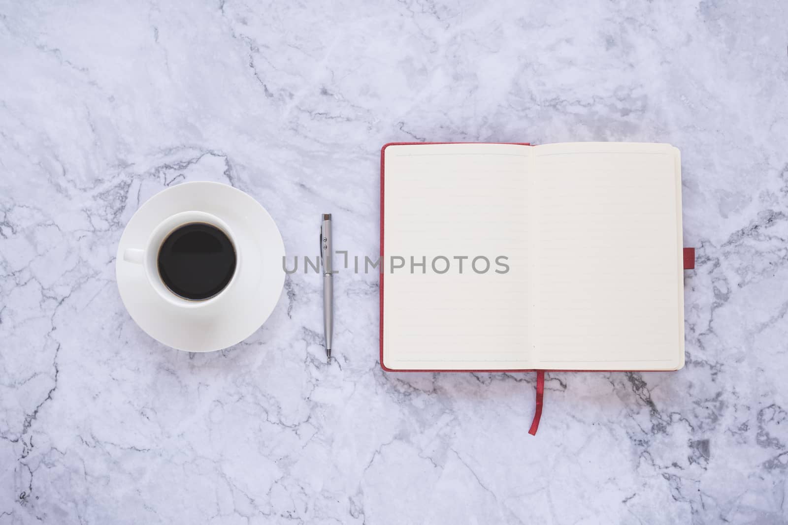 Flat lay creative and designer background with cup of coffee and office tools on white marble background 