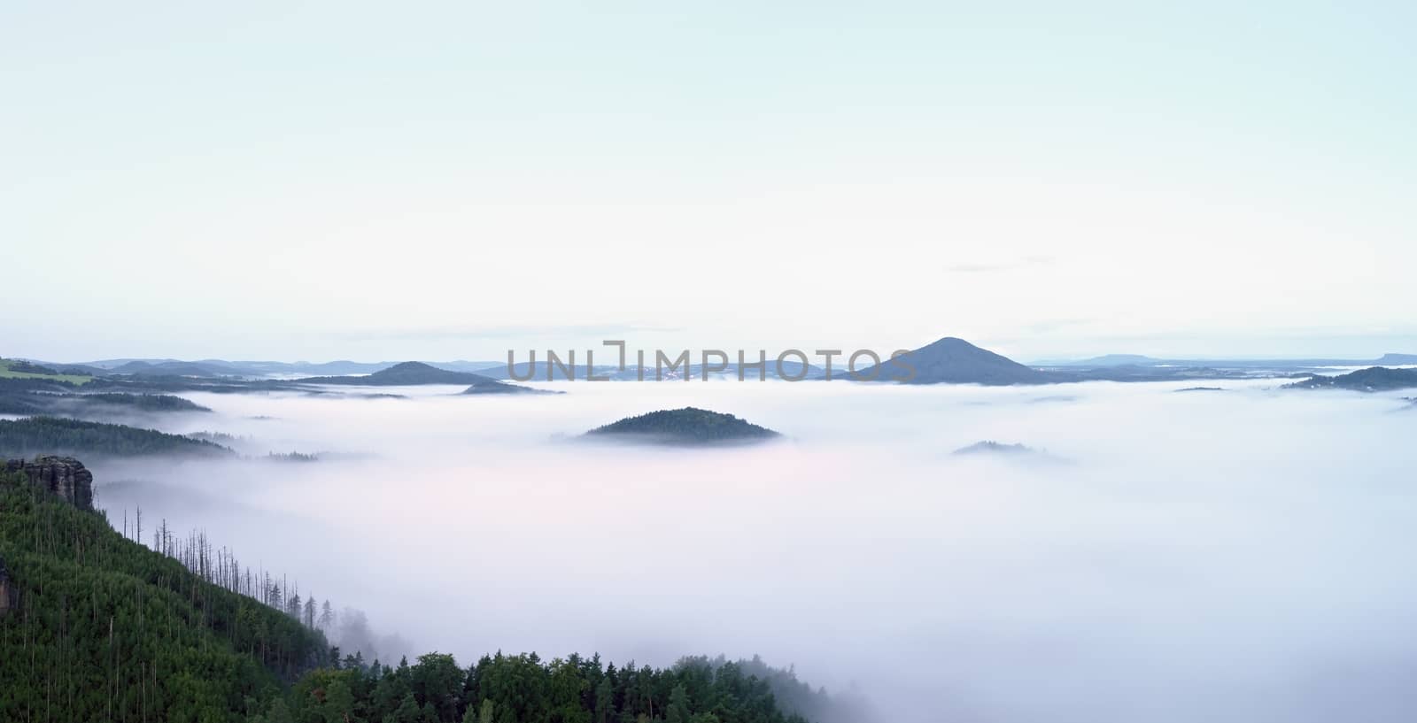 Magnificent heavy mist in landscape. Autumn creamy fog in countryside. Hill increased from fog, by rdonar2