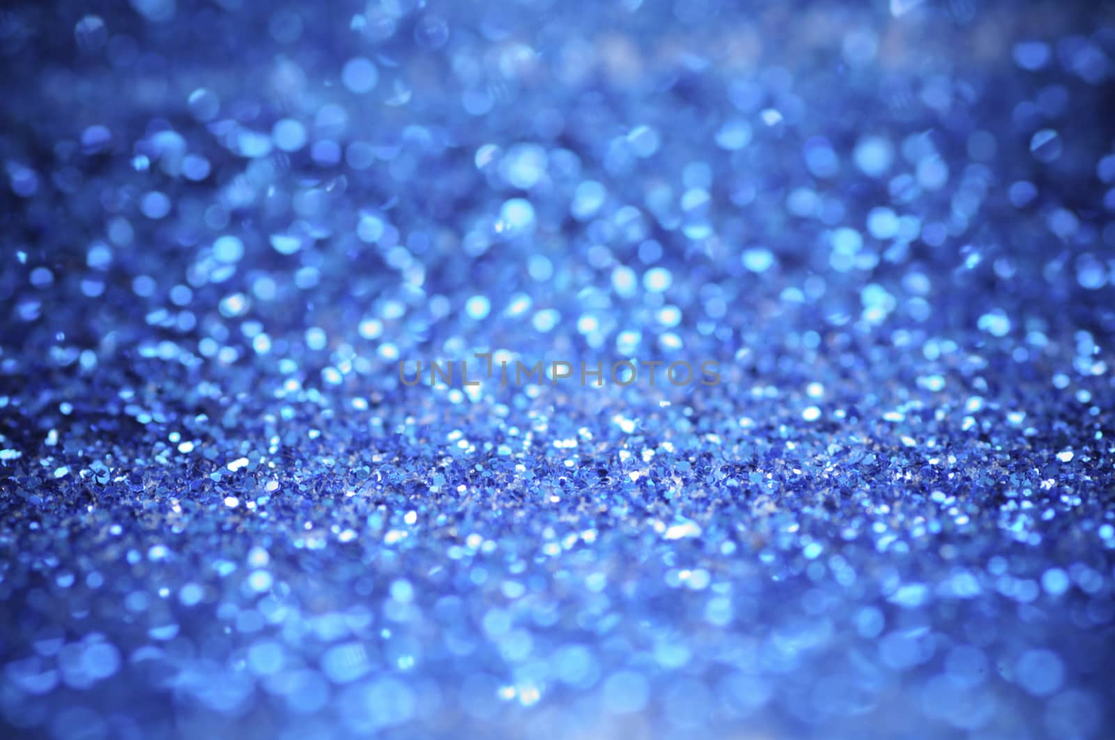 defocus of glitter vintage lights background. blue,white and black for Christmas and new year background.