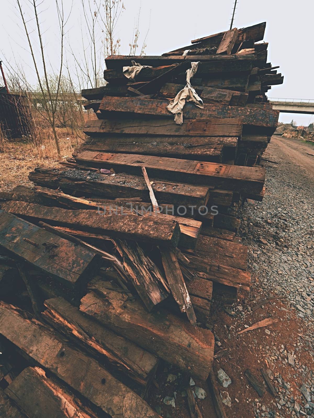 Extracted old wooden ties in stock. Old oiled used oak railway sleepers stored after reconstruction by rdonar2