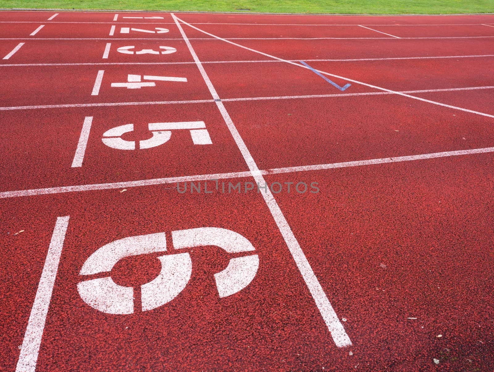 Start. Red running racetrack on the outdoor athletic stadium. Number one,  number two, three, four, five, six. Outdoor excercise.