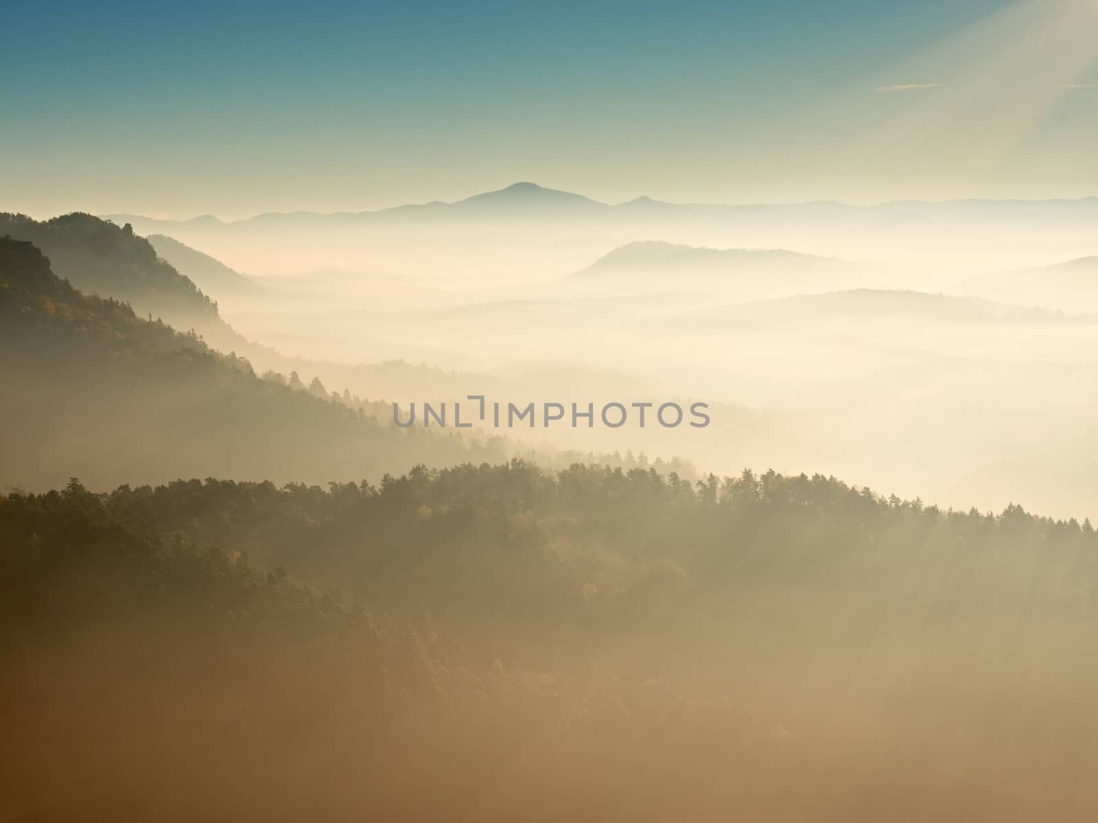 Misty daybreak in a beautiful hills. Gradation of colorful clouds. by rdonar2