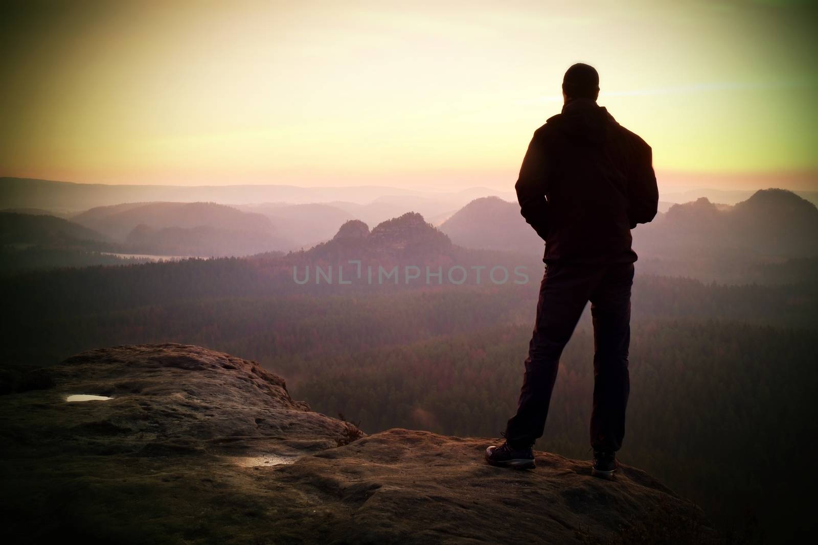 Silhouette of Young Confident and Powerful Man Standing with Hands on Hips, Late Day Sun  by rdonar2