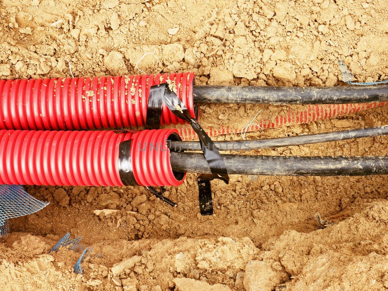 Wire in HDPE and protectivep tube. Building of lines of metallic and fiber optic cables, construction of communication optical network connection. Excavation of trench by hand or mechanized excavator and installation.