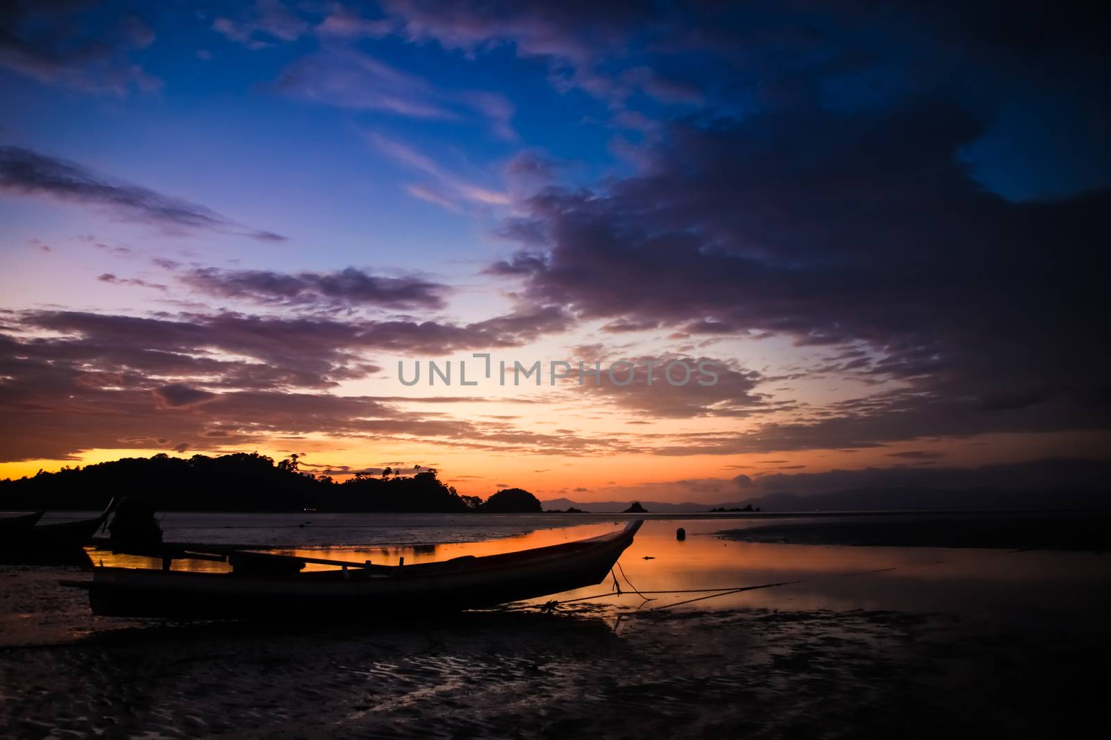 Beautiful Sky and sunset on the beach with Fishing boat silhouette. by anotestocker