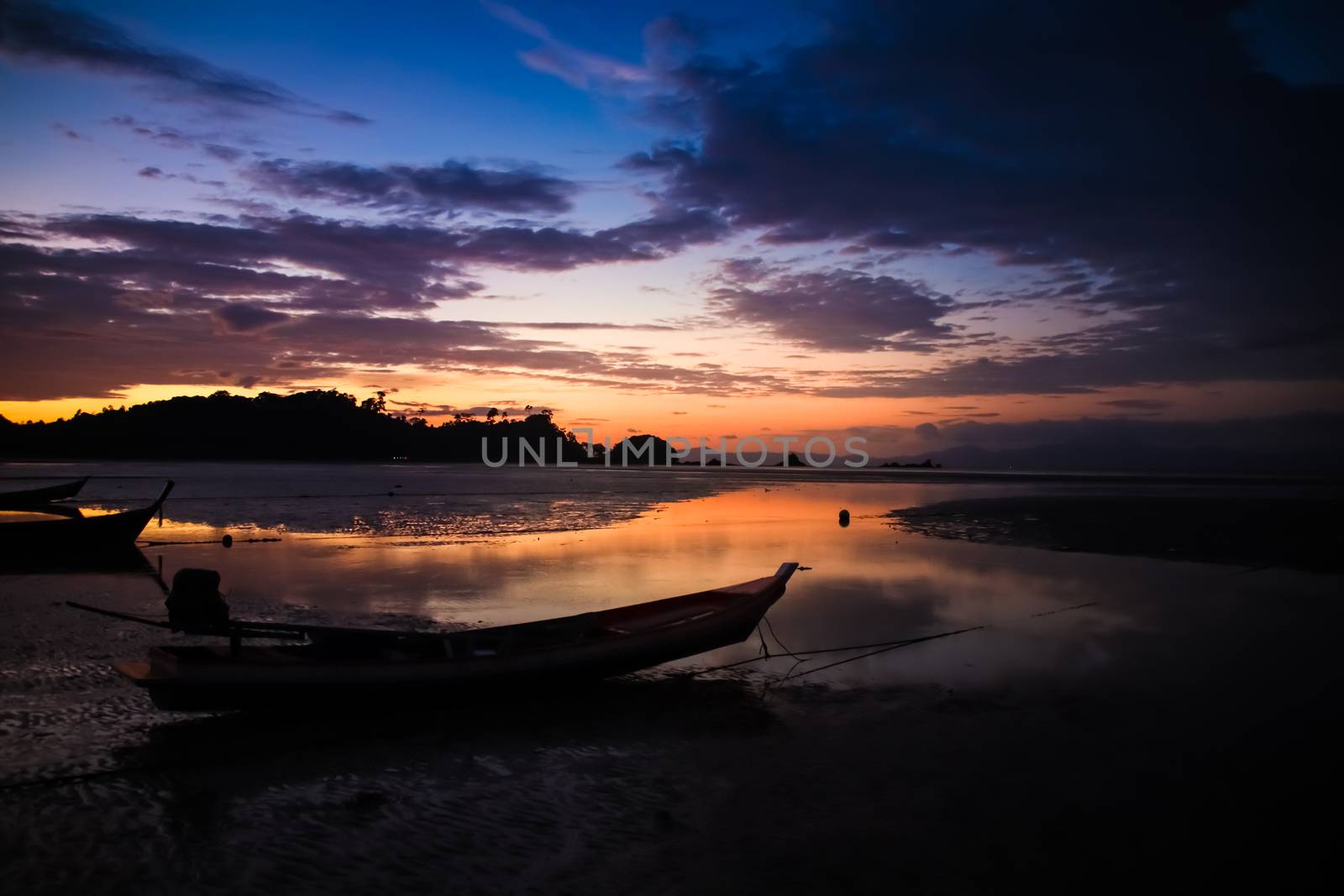 Beautiful Sky and sunset on the beach with Fishing boat silhouette.