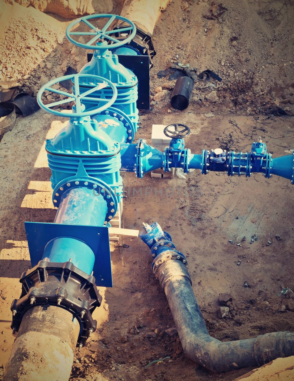 Oil, gas, water industry. Wellhead with valve armature underground. Dug deep trench by rdonar2