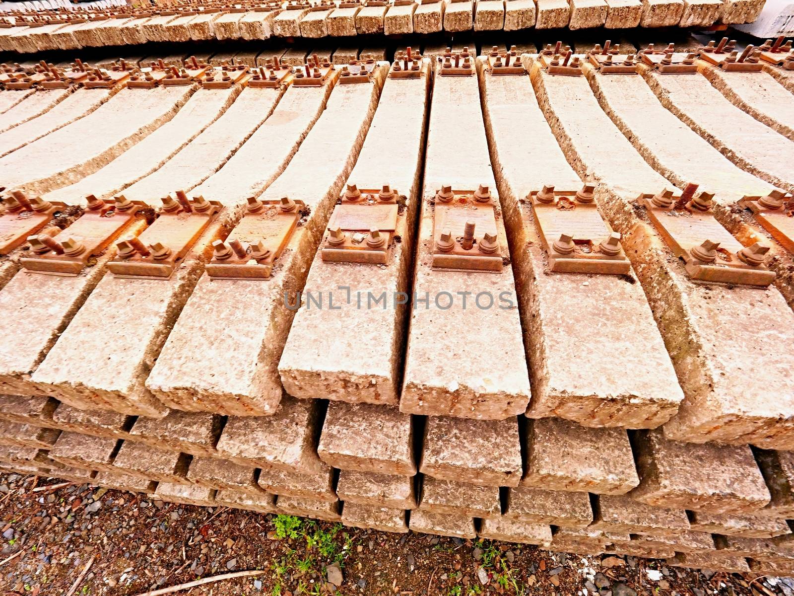 Extracted old concrete sleepers in stock. Old  rusty used concrete railway ties stored after big reconstruction of old railway station. 