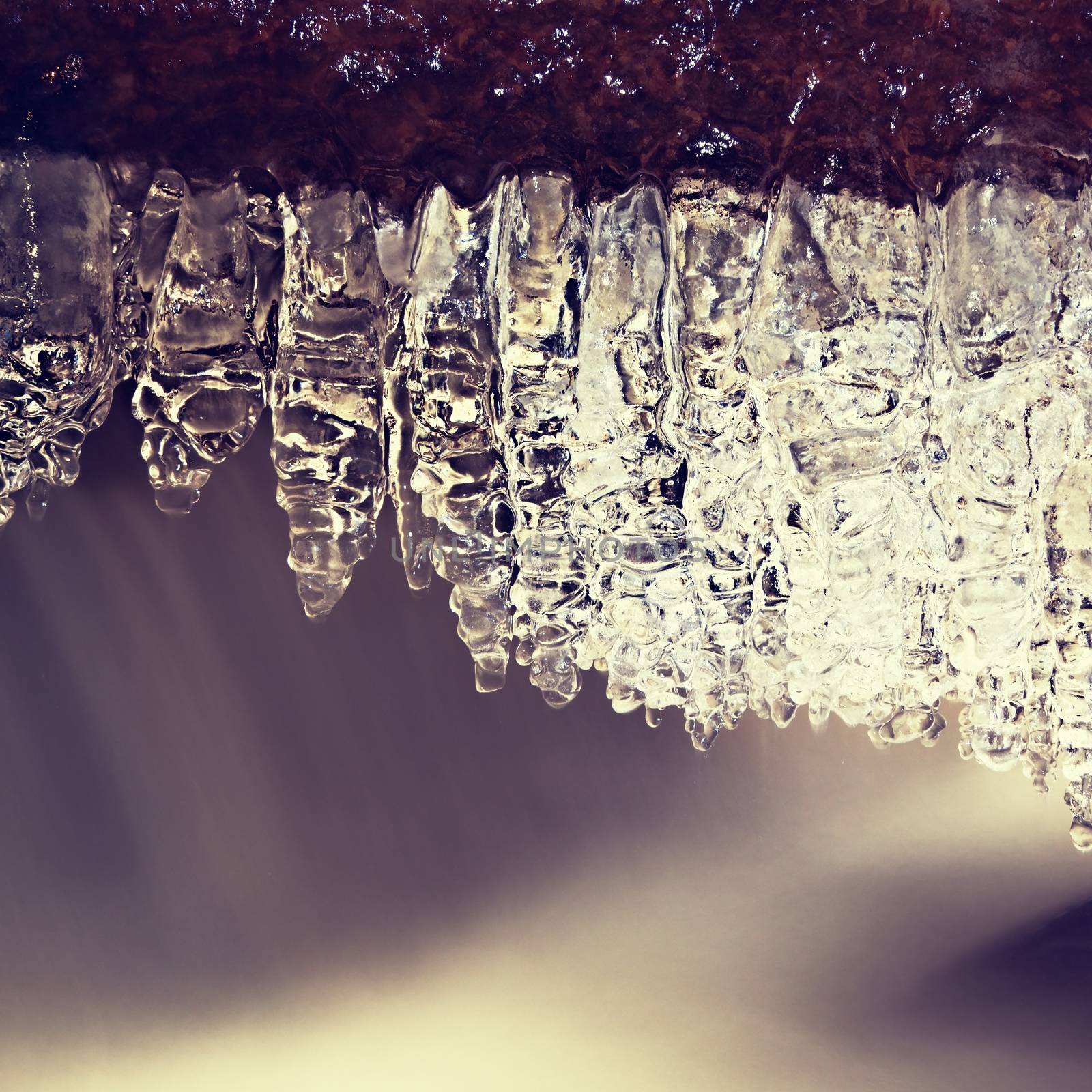 Winter creek  with icicles above freeze  mountain stream. Winter season by rdonar2