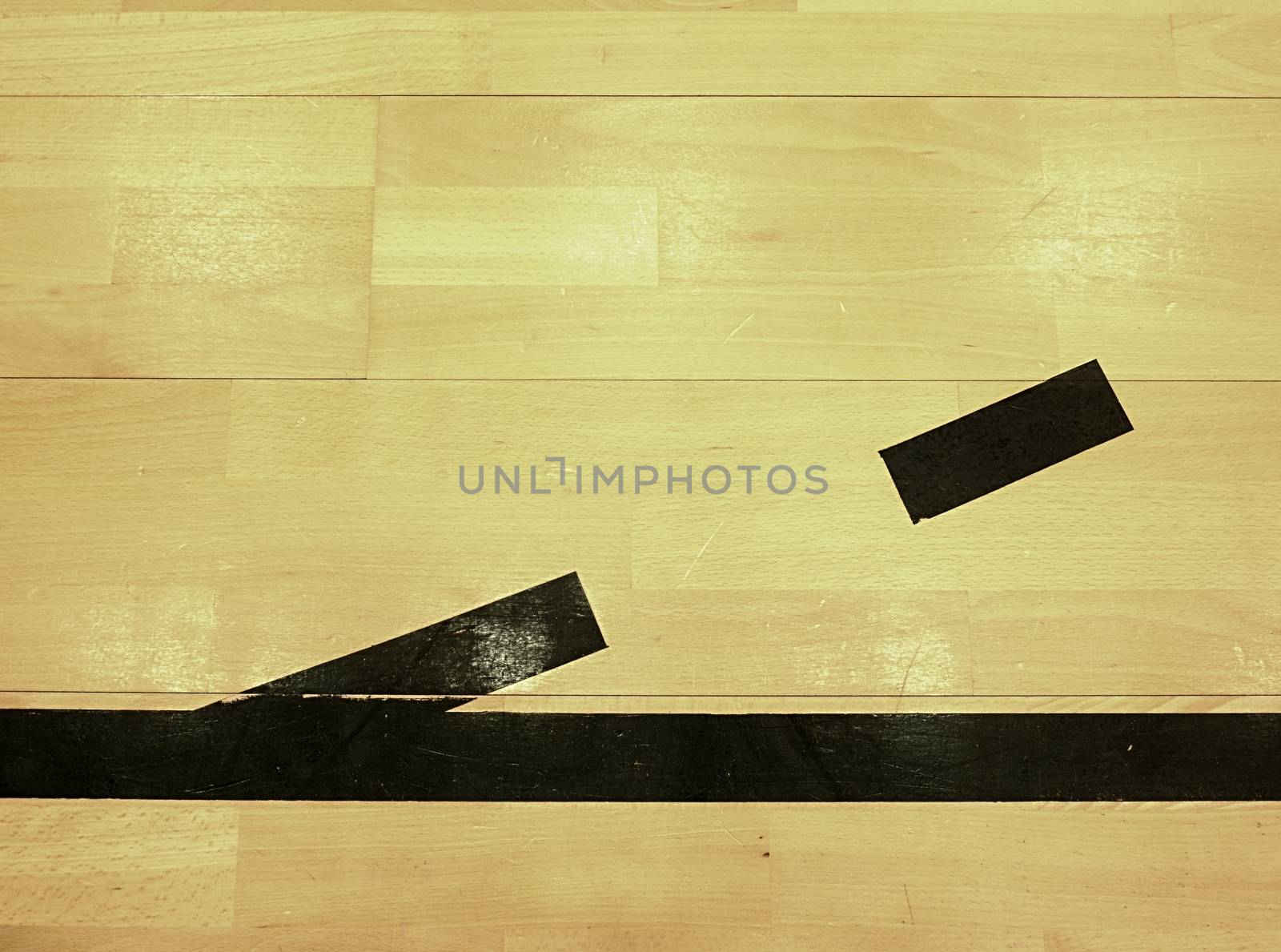 Black dotted lines in hall playground. Worn out wooden floor of sports hall with colorful marking lines. Schooll gym hall
