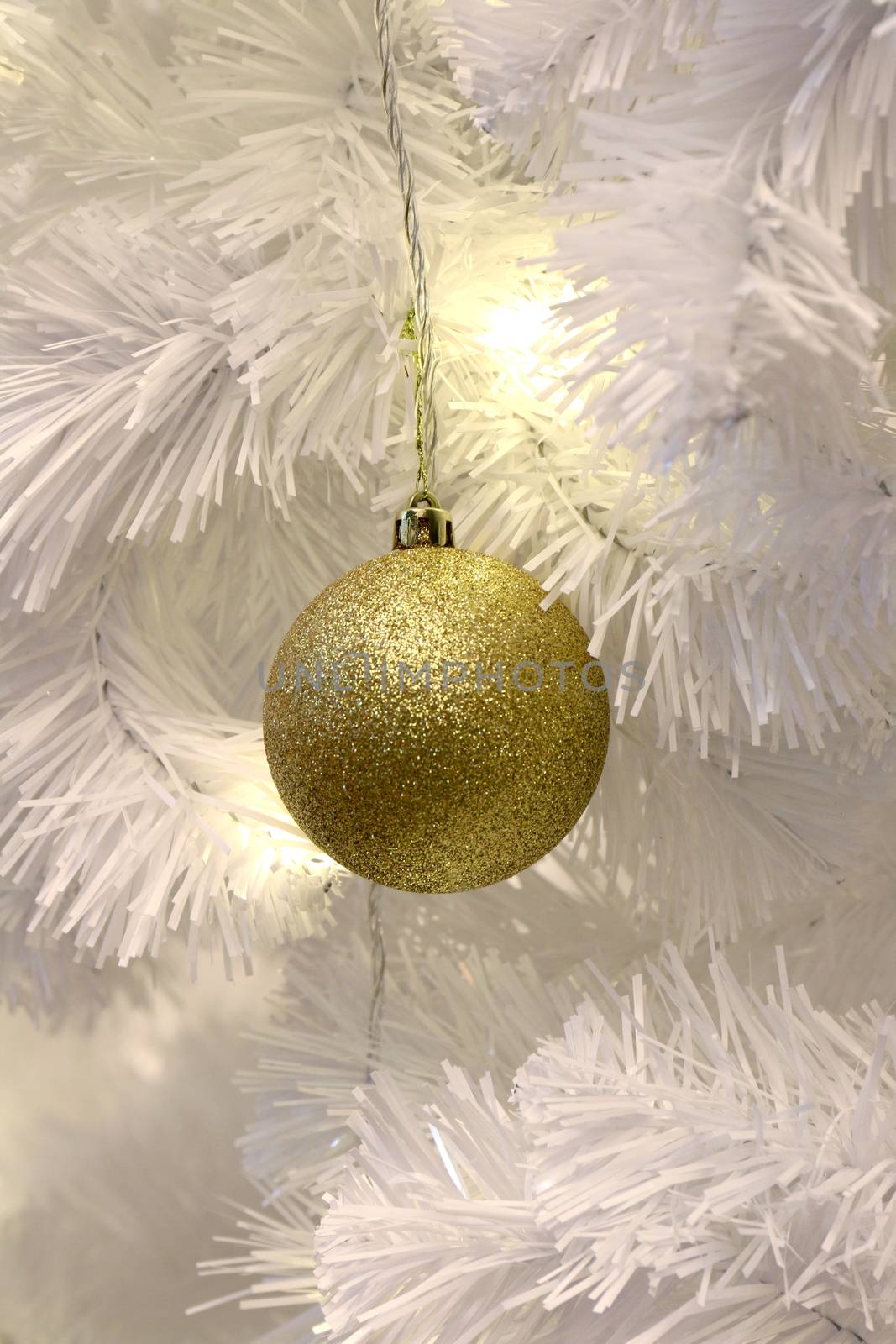 Golden ball on White Christmas tree background decoration (selective focus) by cgdeaw