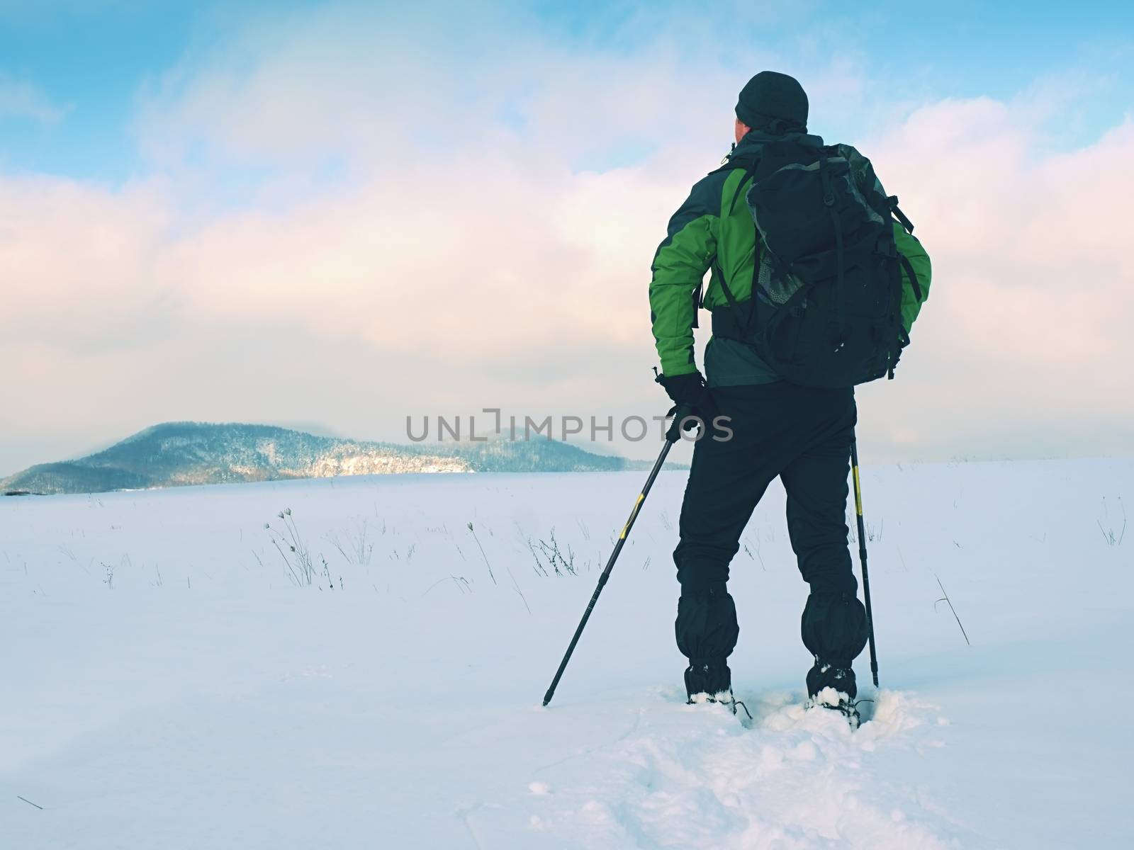 Snowshoes walk. Winter trekking in fresh powder snow with snowshoes.