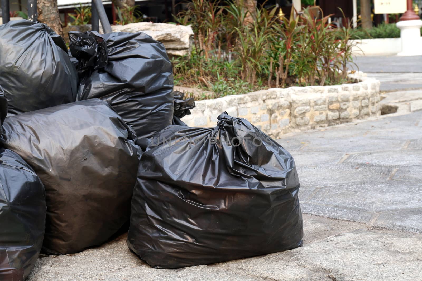 Waste plastic, Lots pile of garbage black bags stack on the floor ground public park, many dump black garbage plastic bags stack