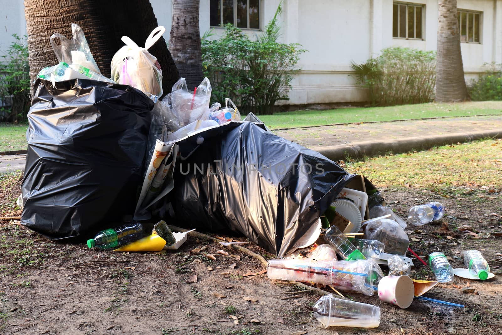 Pile of Garbage plastic black and trash bag waste many on the footpath, pollution trash, Plastic Waste and Bag Foam tray Garbage many on floor, Waste plastic