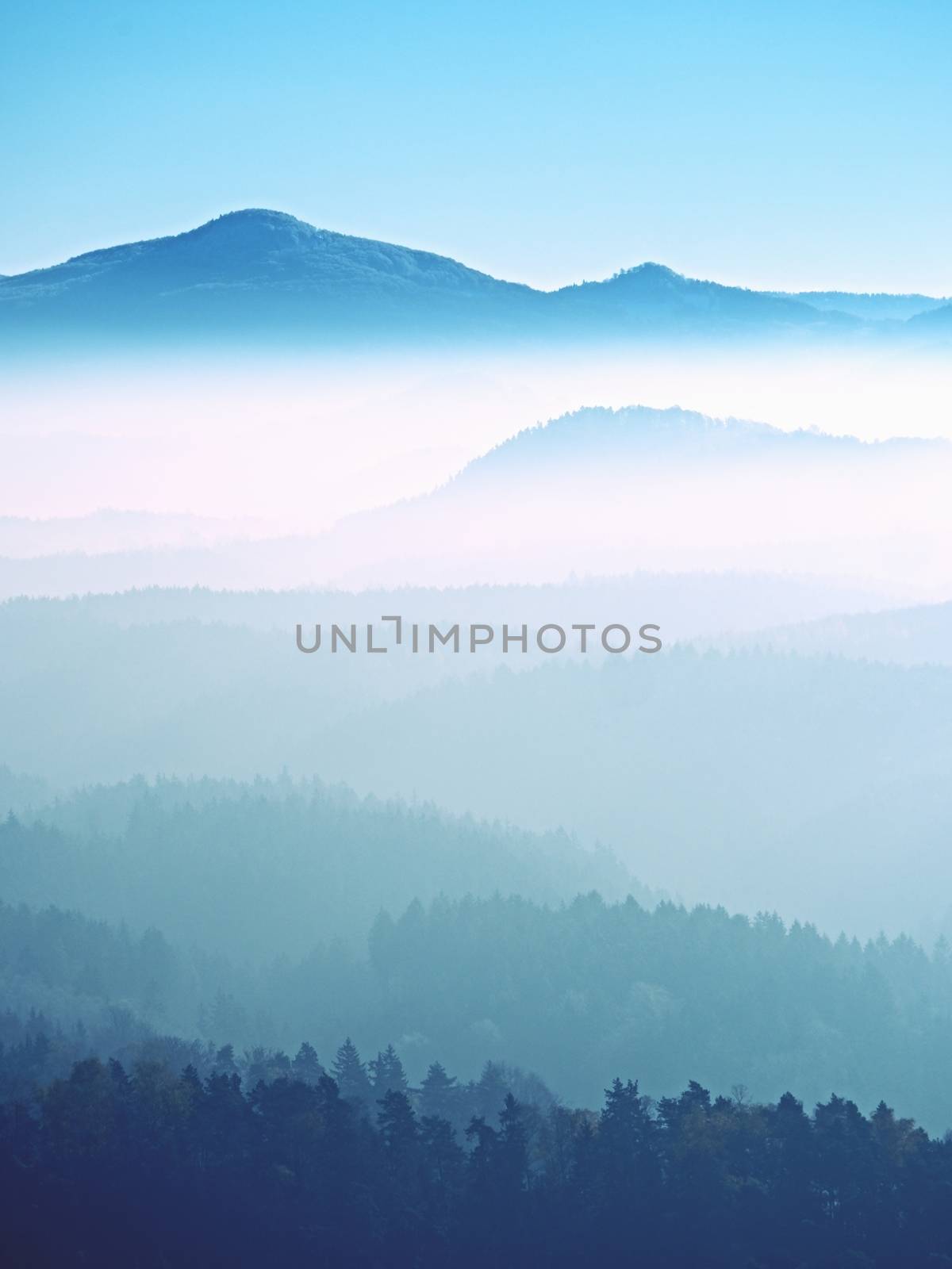 View on a big rounded hill from plane, beautiful fantastic view. Fantastic dreamy sunrise, mountain above misty valley. Tourist resort.