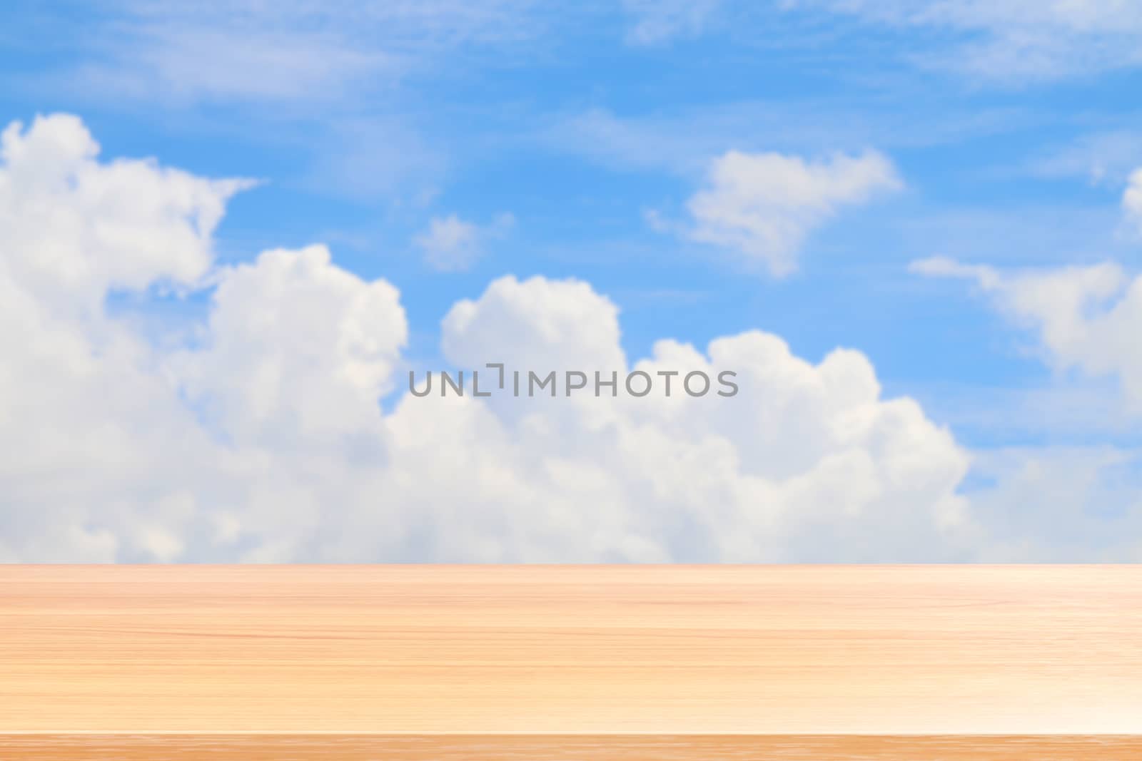 empty wood table floors on blurred blue sky and cloud background, wood table board empty front blur sky blue, wooden plank blank on sky with perspective brown wood table for mock up display products