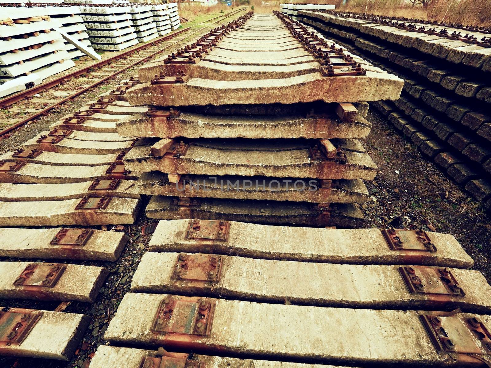 Extracted old concrete sleepers in stock. Old  rusty used concrete railway ties stored after big reconstruction of old railway station. 
