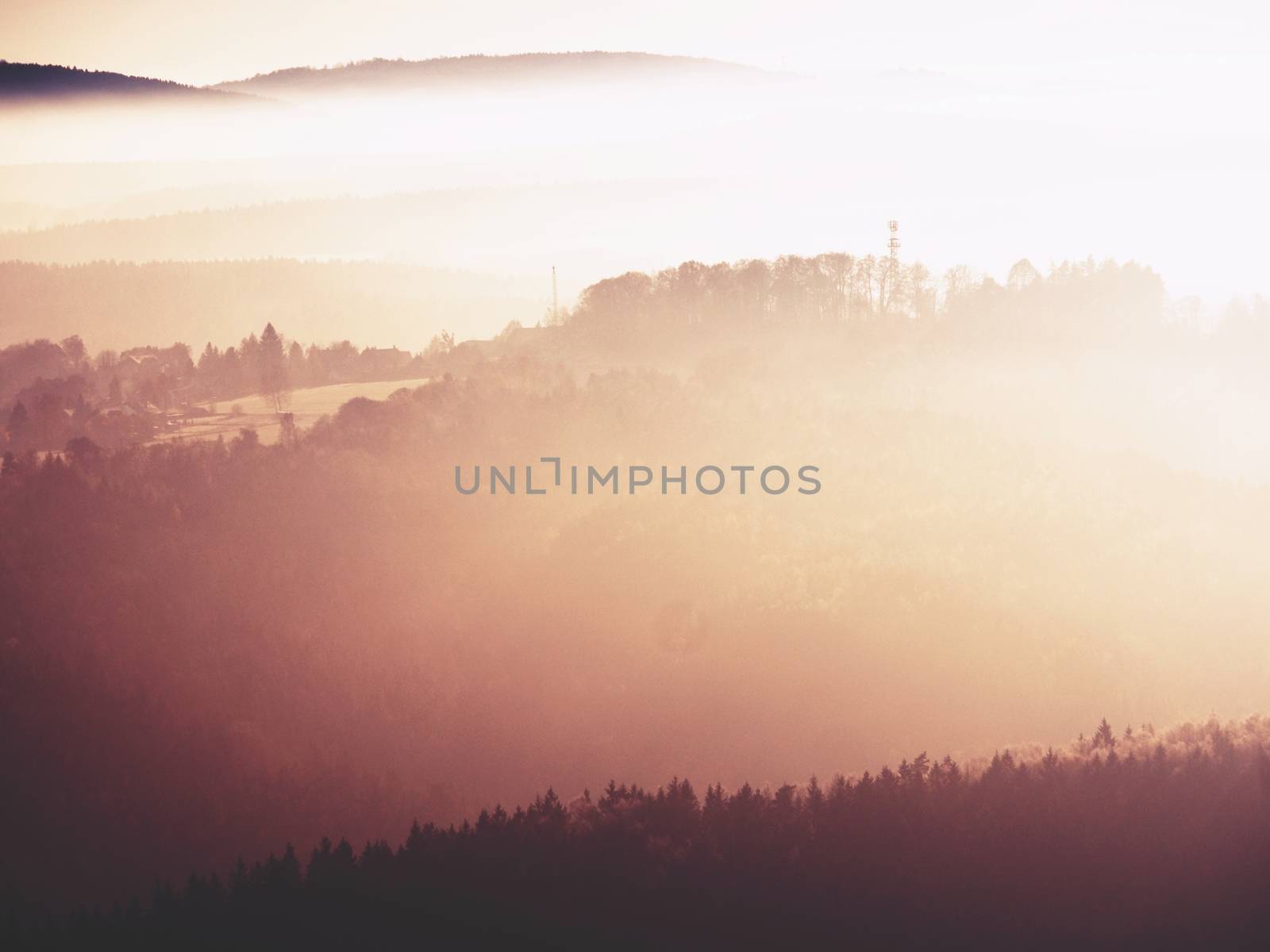View on a big rounded hill from plane, beautiful fantastic view. Fantastic dreamy sunrise, mountain above misty valley. Tourist resort.