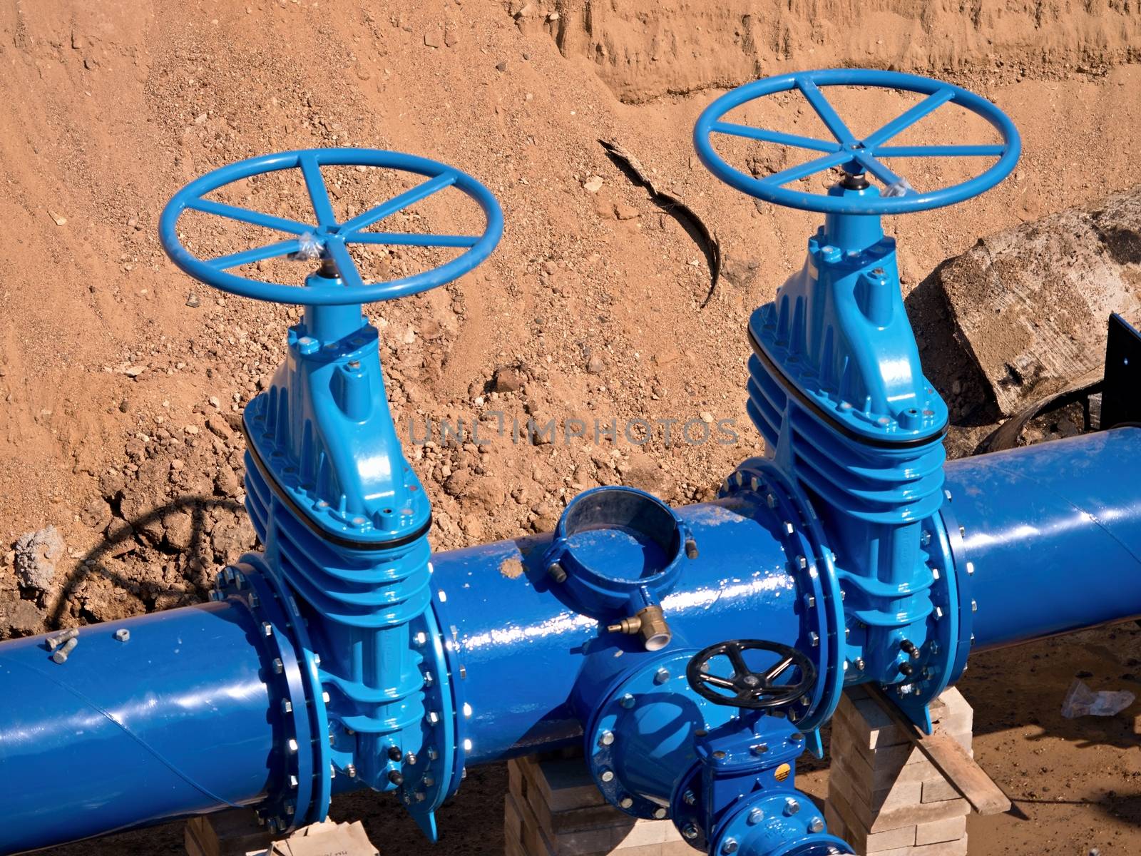 Gate valves underground, water pipeline valve on a blue pipeline after complete reconstruction. 