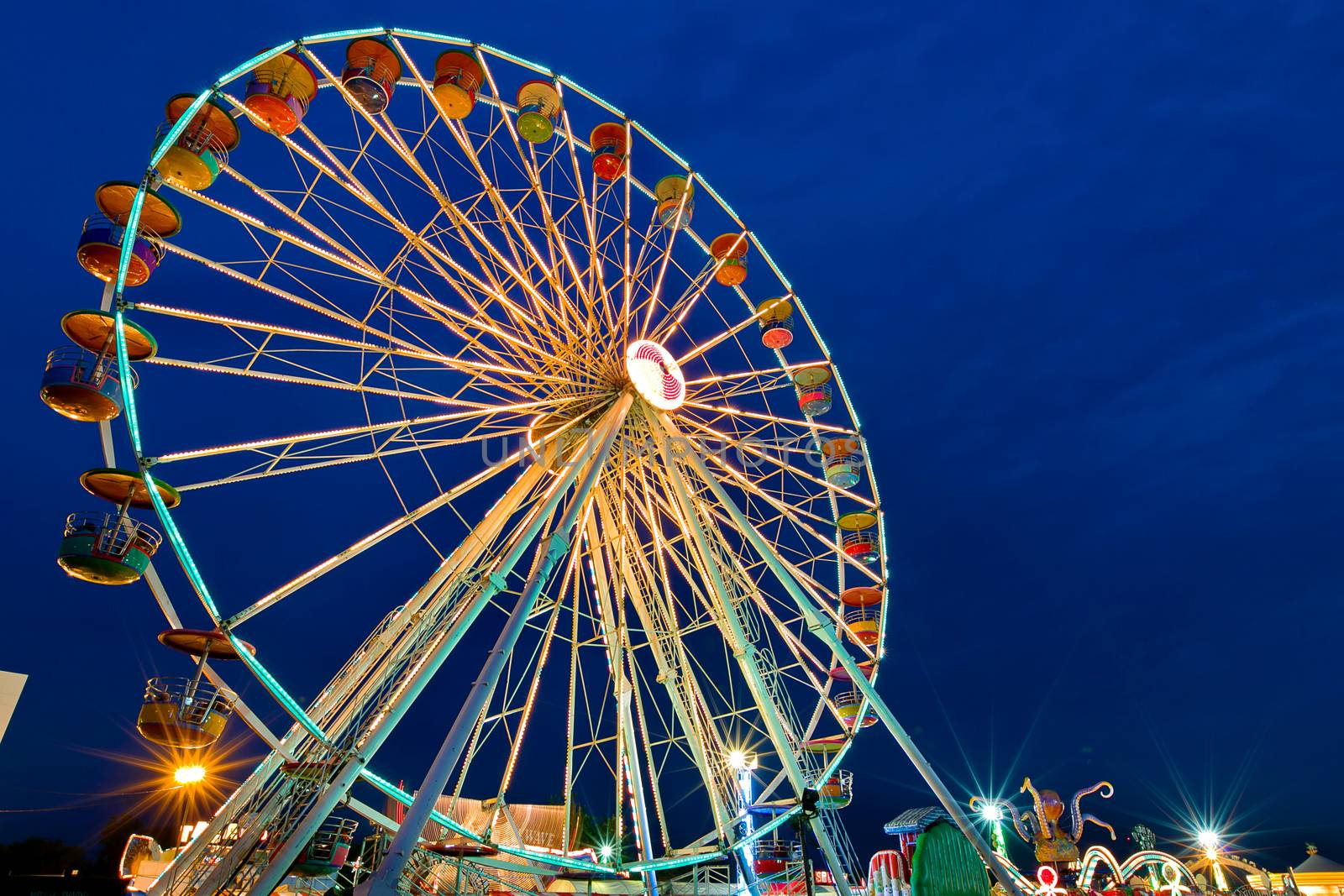 Ferris wheel with outdoor long exposure at twilight. by jayzynism