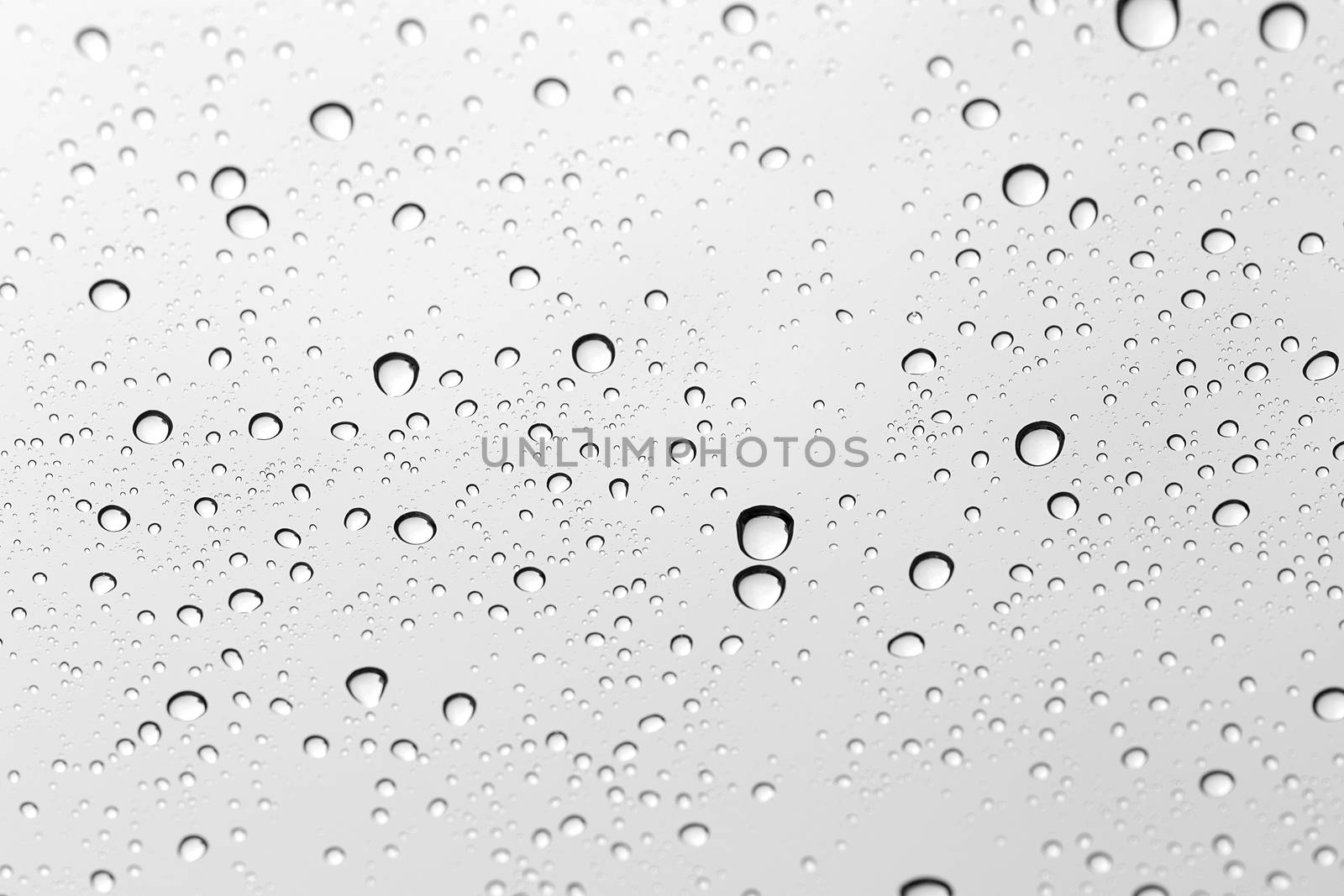 Water drop on glass mirror background.