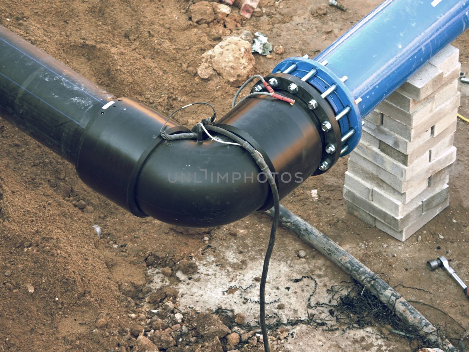 HDPE pipe welding underground, City portable water system.  Welding of water supply plastic tubes,  excavation pit
