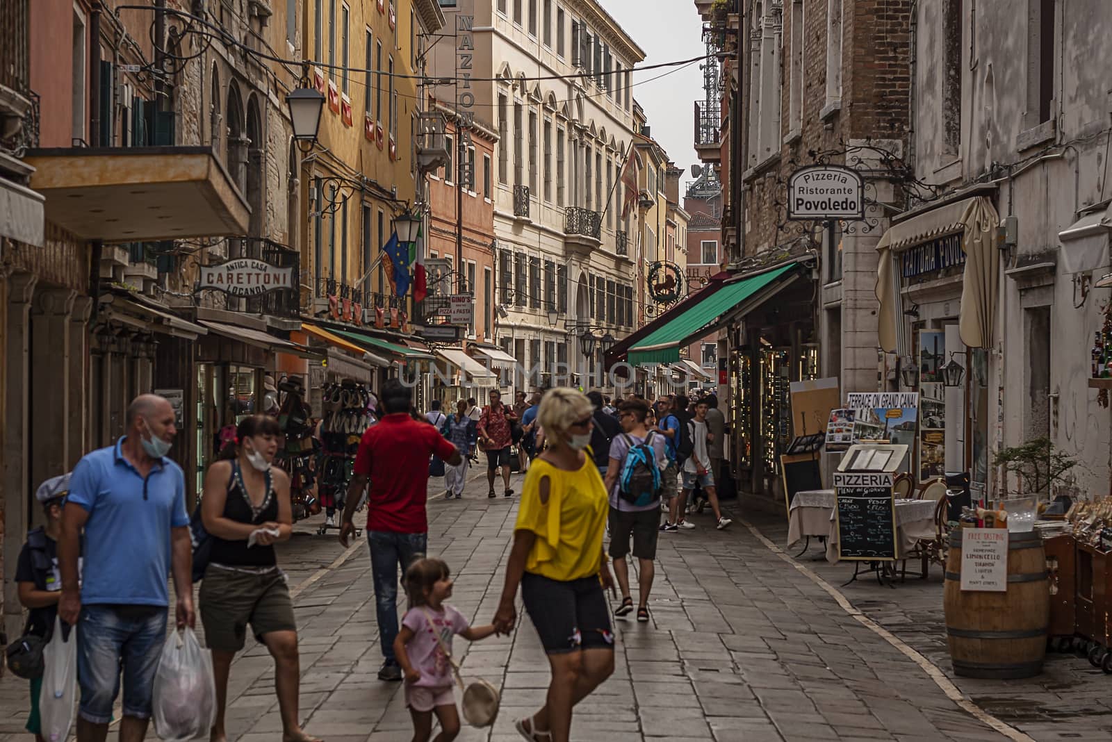 Tourists walk in Venice street by pippocarlot