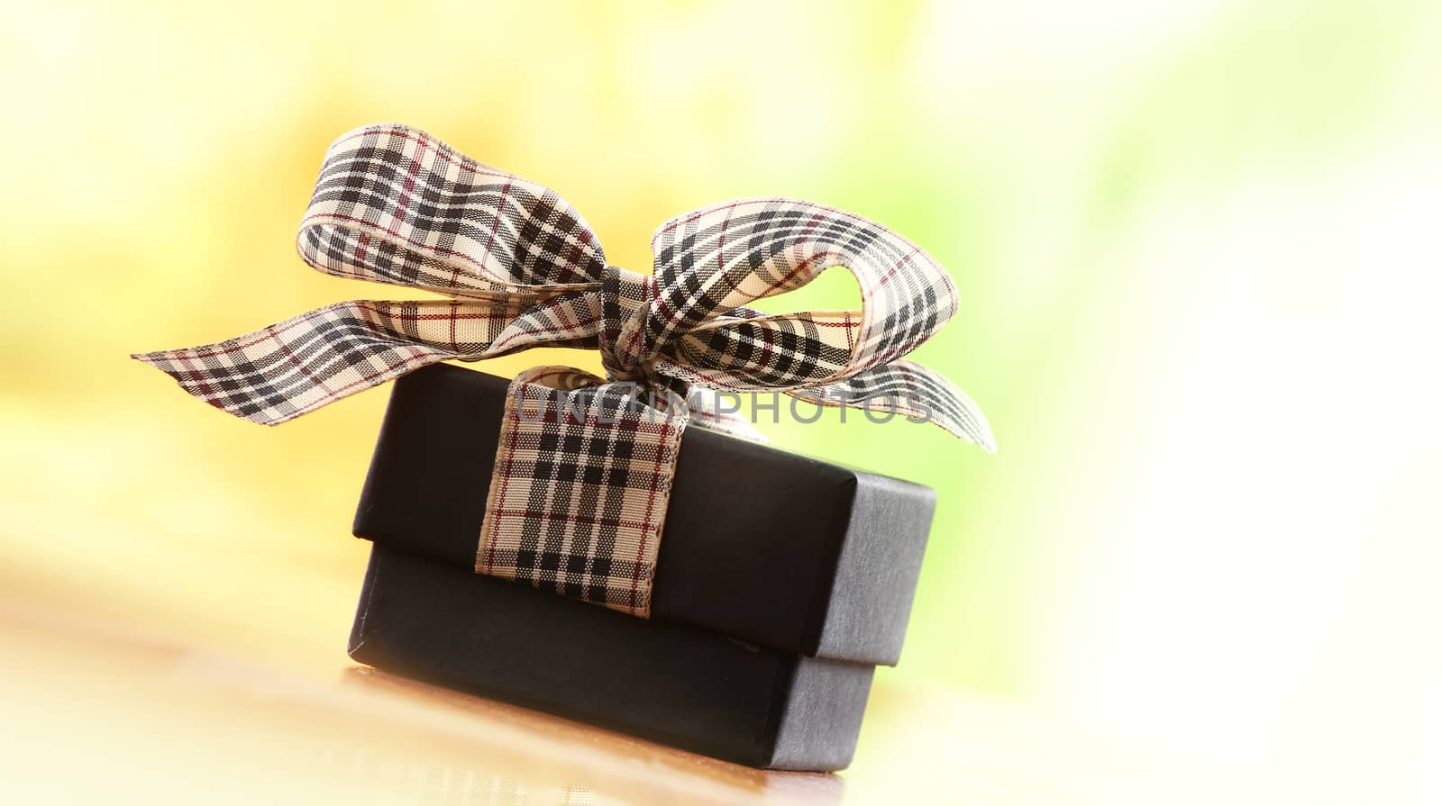 brown christmas present with ribbon. Presents in a table with decoration and copy space and a ribbon