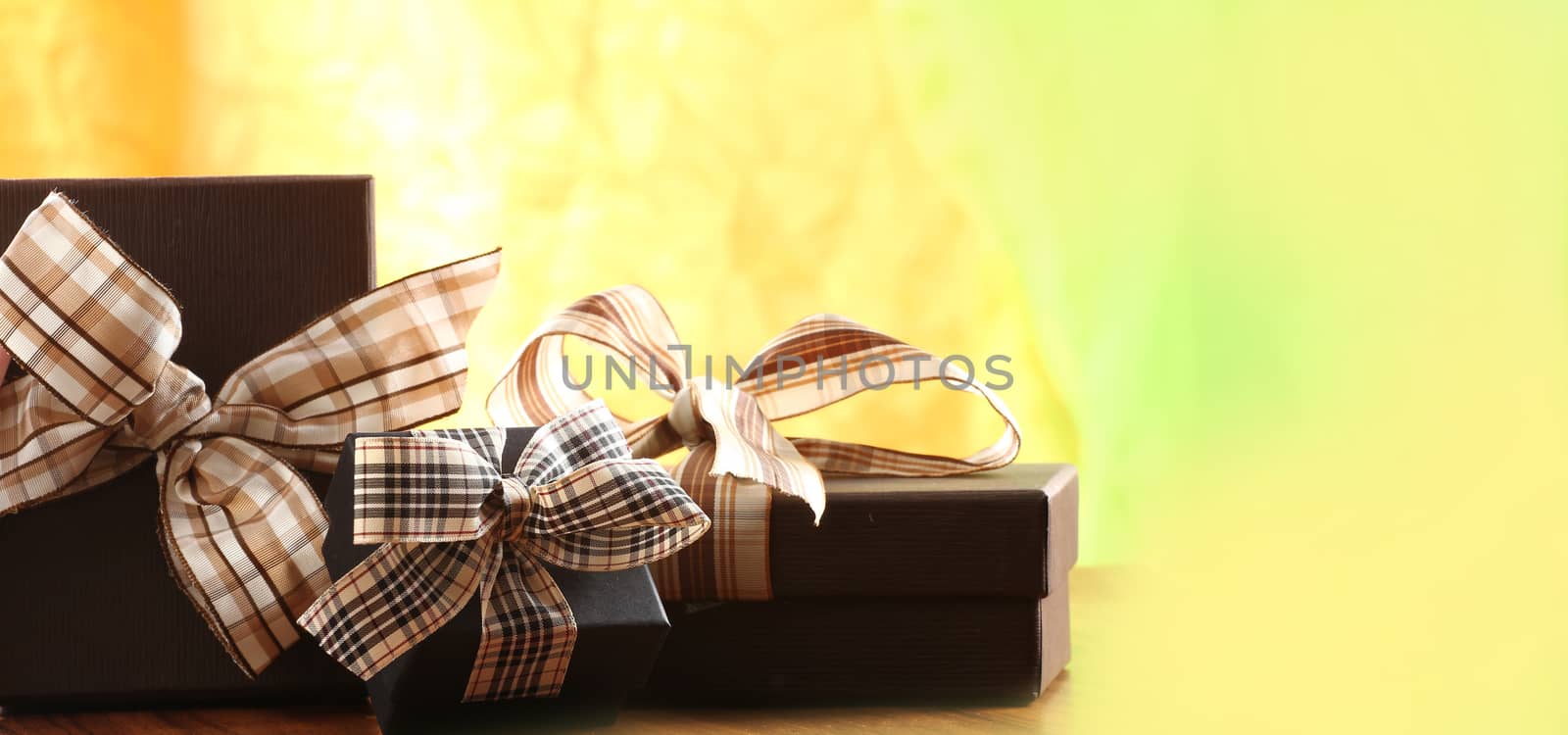 brown christmas present with ribbon. Presents in a table with decoration and copy space and a ribbon