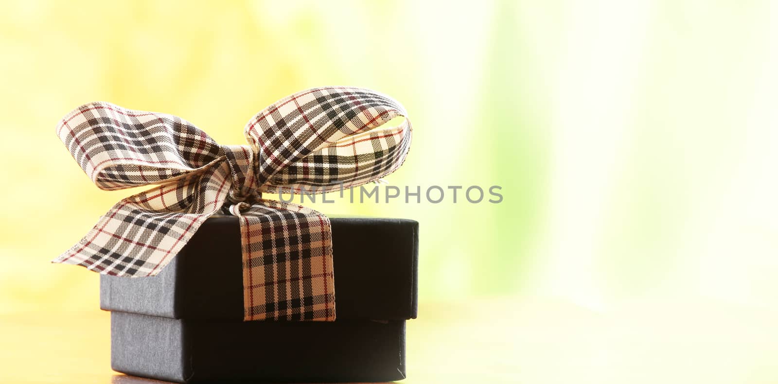 brown christmas present with ribbon. Presents in a table with decoration and copy space and a ribbon