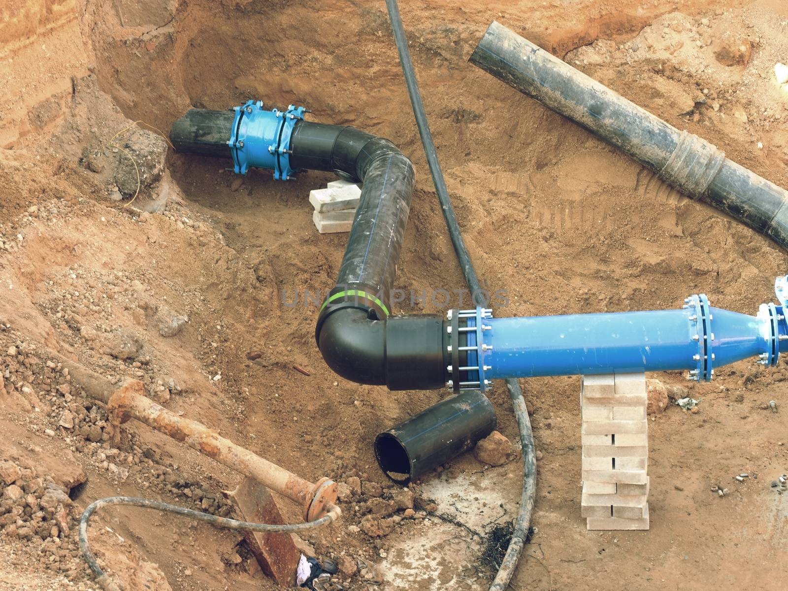 HDPE pipe welding underground, City portable water system.  Welding of water supply plastic tubes,  excavation pit