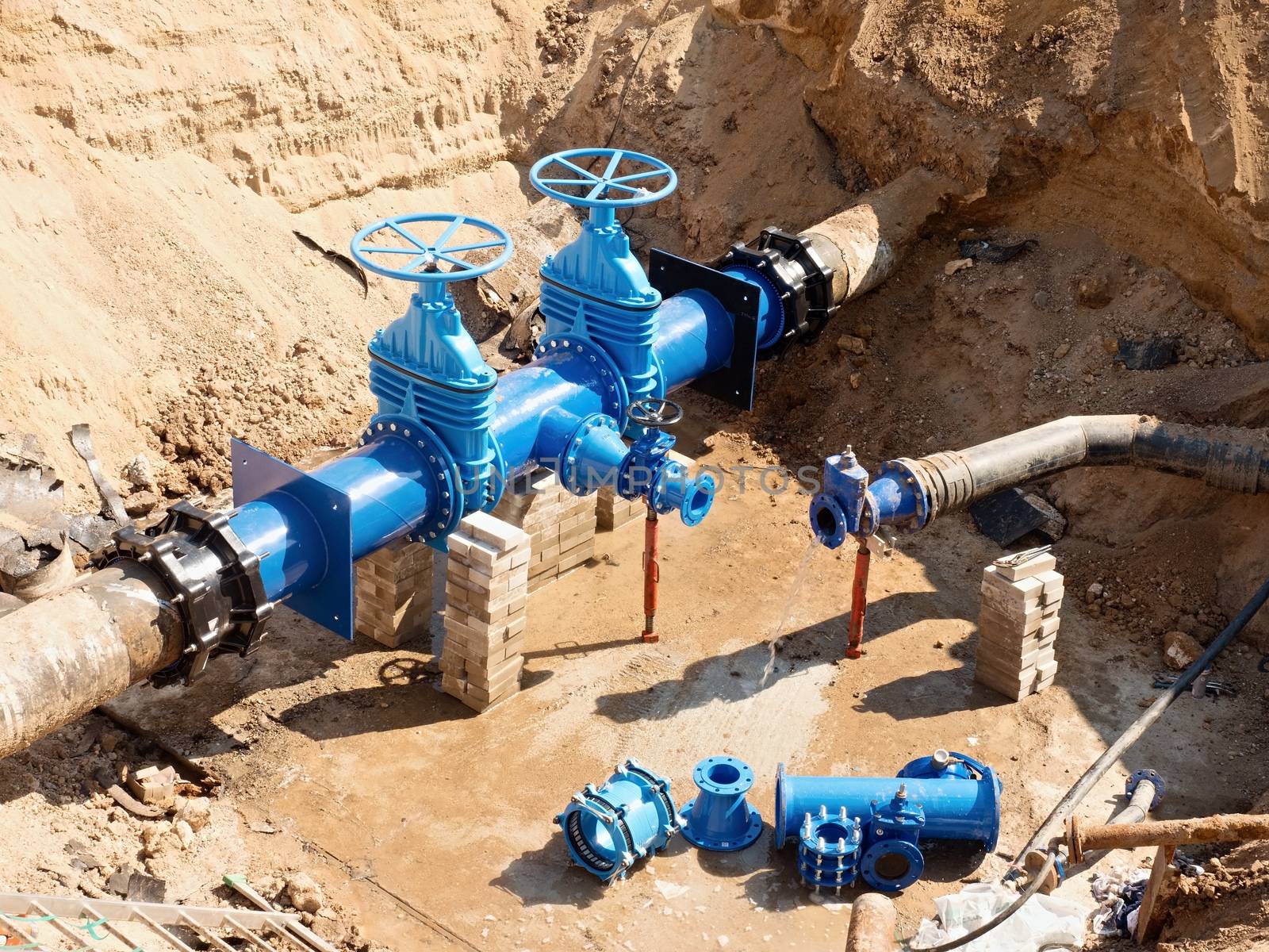 Drink Water Factory. Various pipelines, valve gates and metal pipes. Toned image. Repairing of pipeline underground.