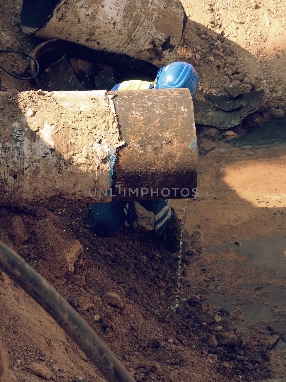 Man works, big pipe cutting with spiral machine. Hor sparks flying away from cut place. by rdonar2