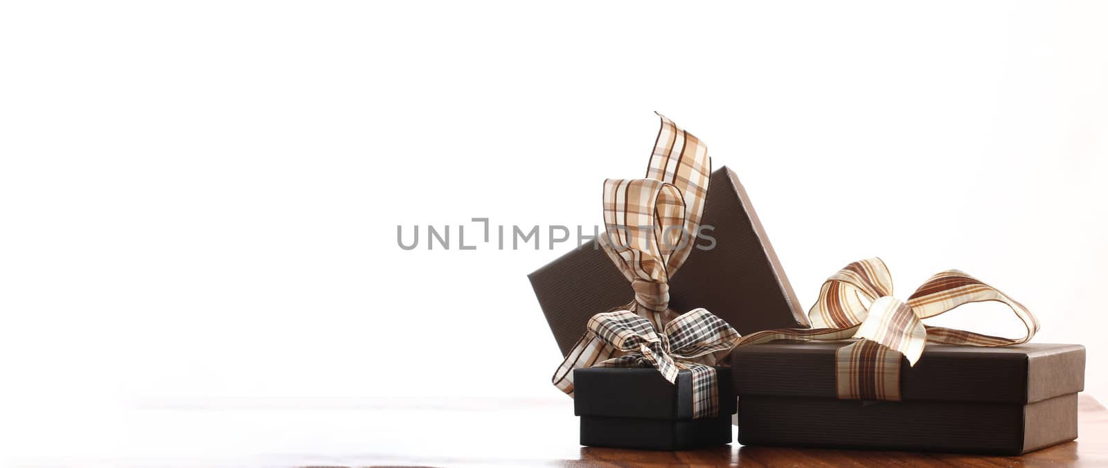 brown christmas present with ribbon. Presents in a table with decoration by PeterHofstetter