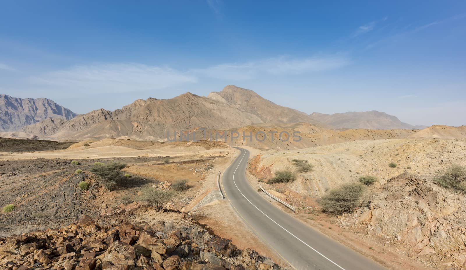 A road going thru the deserted mountains of the Sultanate of Oma by GABIS