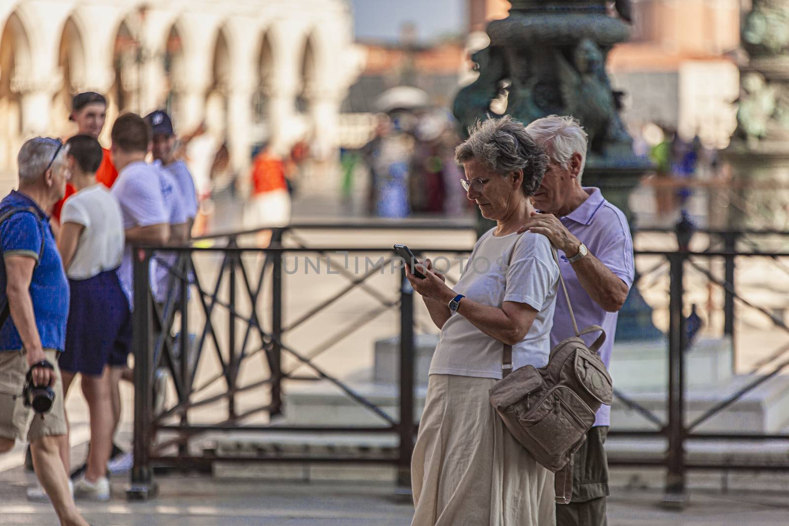 VENICE, ITALY 2 JULY 2020: Old people with smartphone