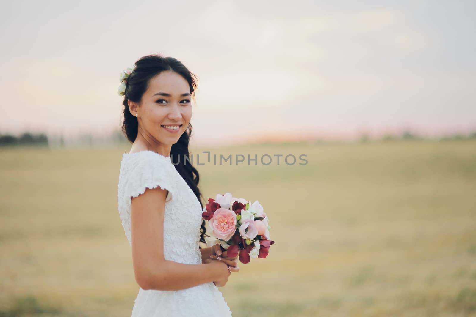 Beautiful bride holds a bouquet in her hands. Wedding. Bridal bouquet. Happy love concept. by selinsmo
