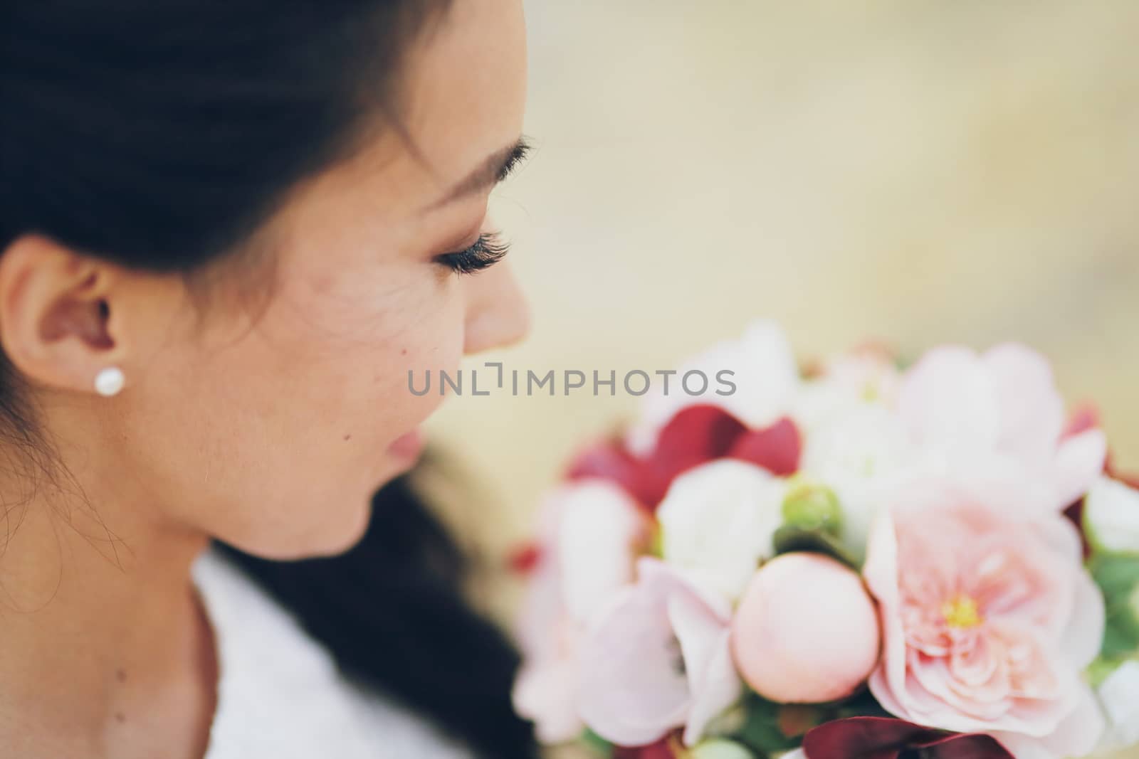 Beautiful bride holds a bouquet in her hands. Wedding. Bridal bouquet. Happy love concept. High quality photo