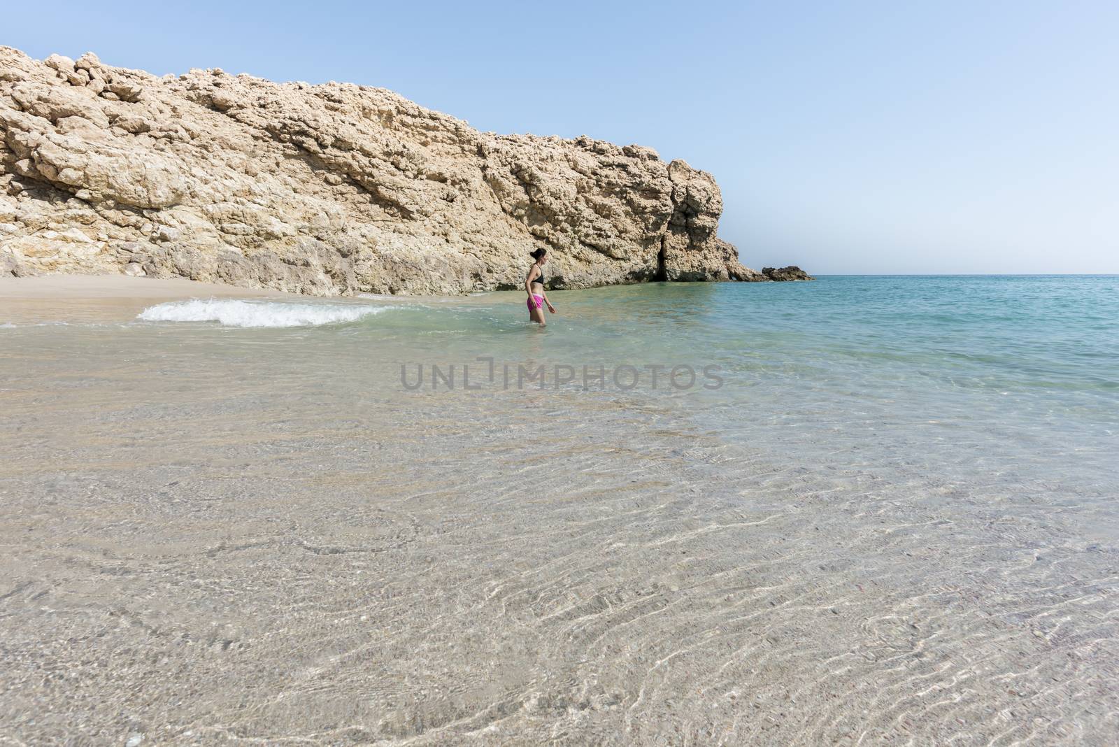 Woman alone at a wild and idyllic Beach of Ras Al Jinz, Oman by GABIS