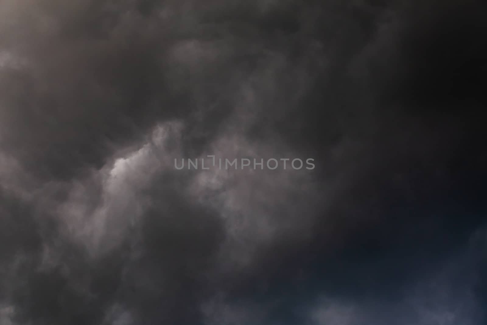 gray incoming storm clouds dark closeup backdrop, captured on 100 mm telephoto lens