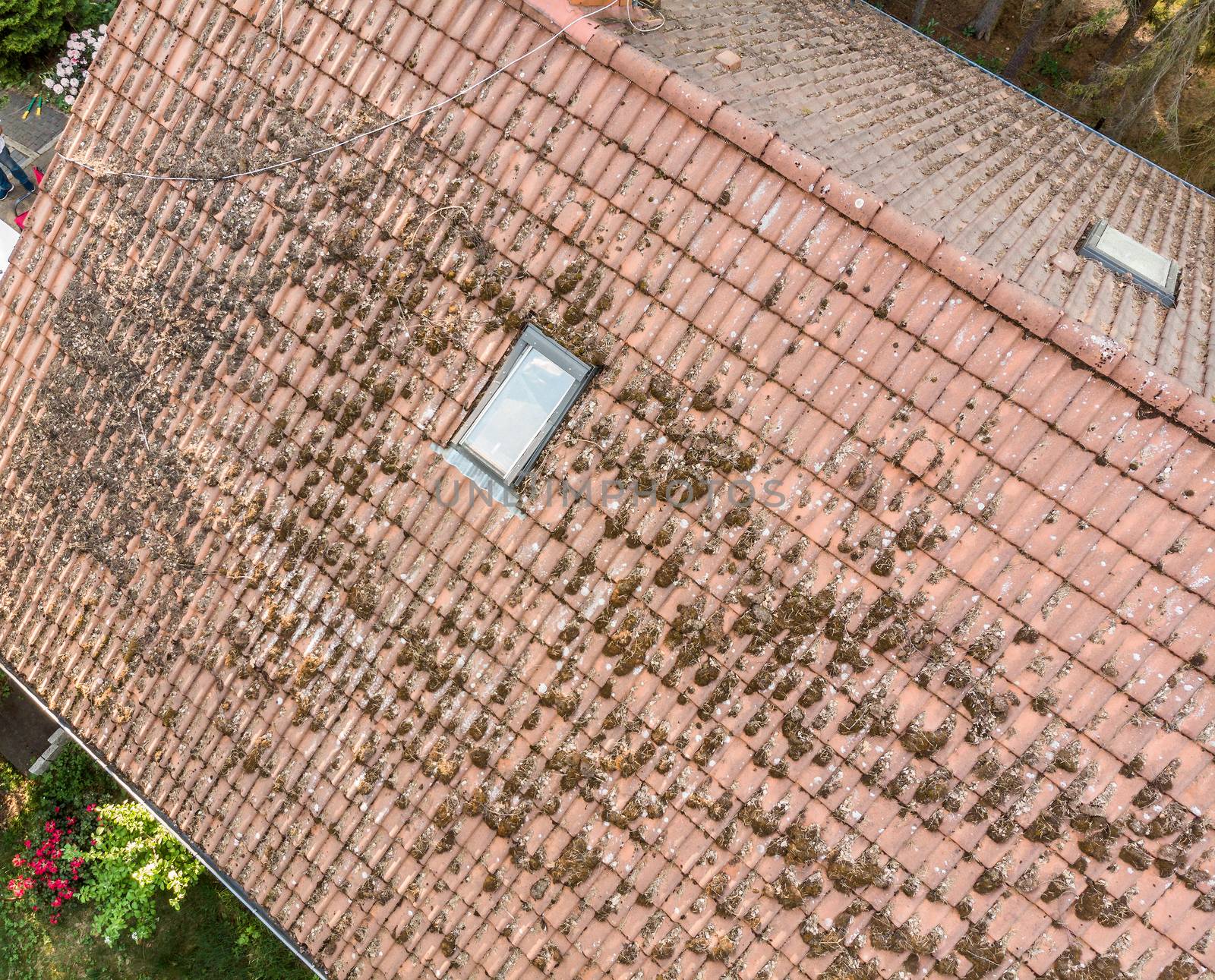 Overflight of the roof of a single-family house to check the condition of the roof tiles, aerial view made with drone