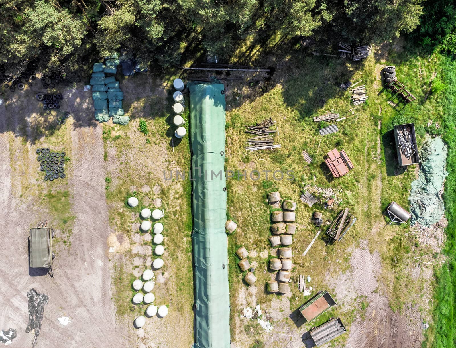 Detailed view from the air of a storage place for a farm, with silage, hay and straw, aerial view by geogif