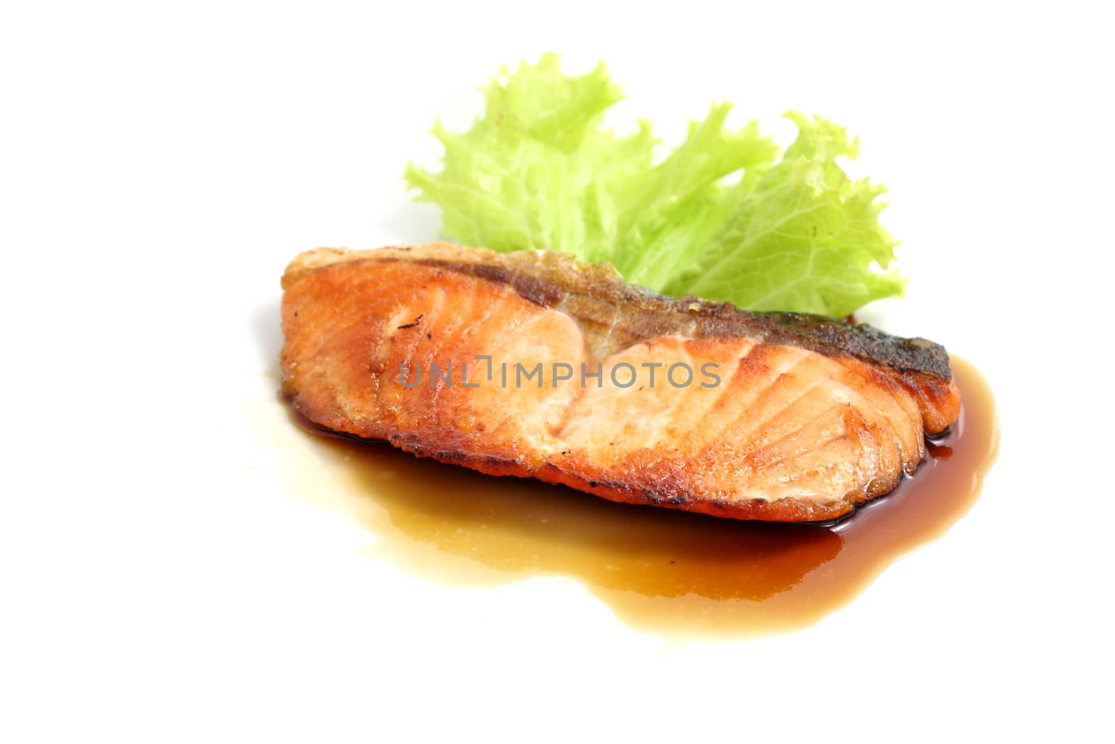 grilled salmon with teriyaki sauce isolated in white background by piyato