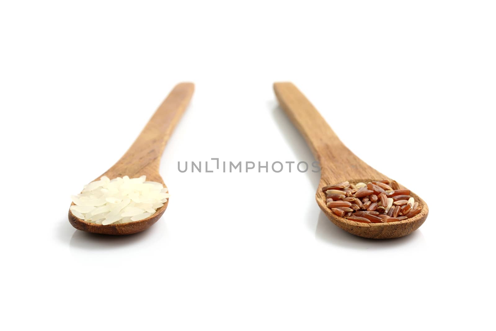 Rice on wood spoon isolated in white background by piyato