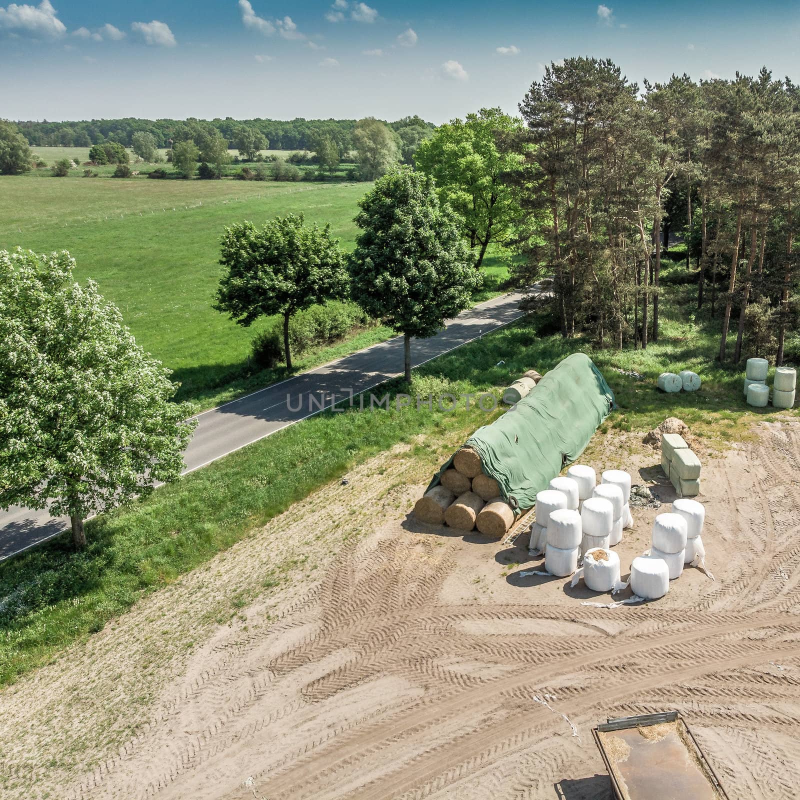 Detailed view from the air of a storage place for a farm, with silage, hay and straw, aerial view by geogif