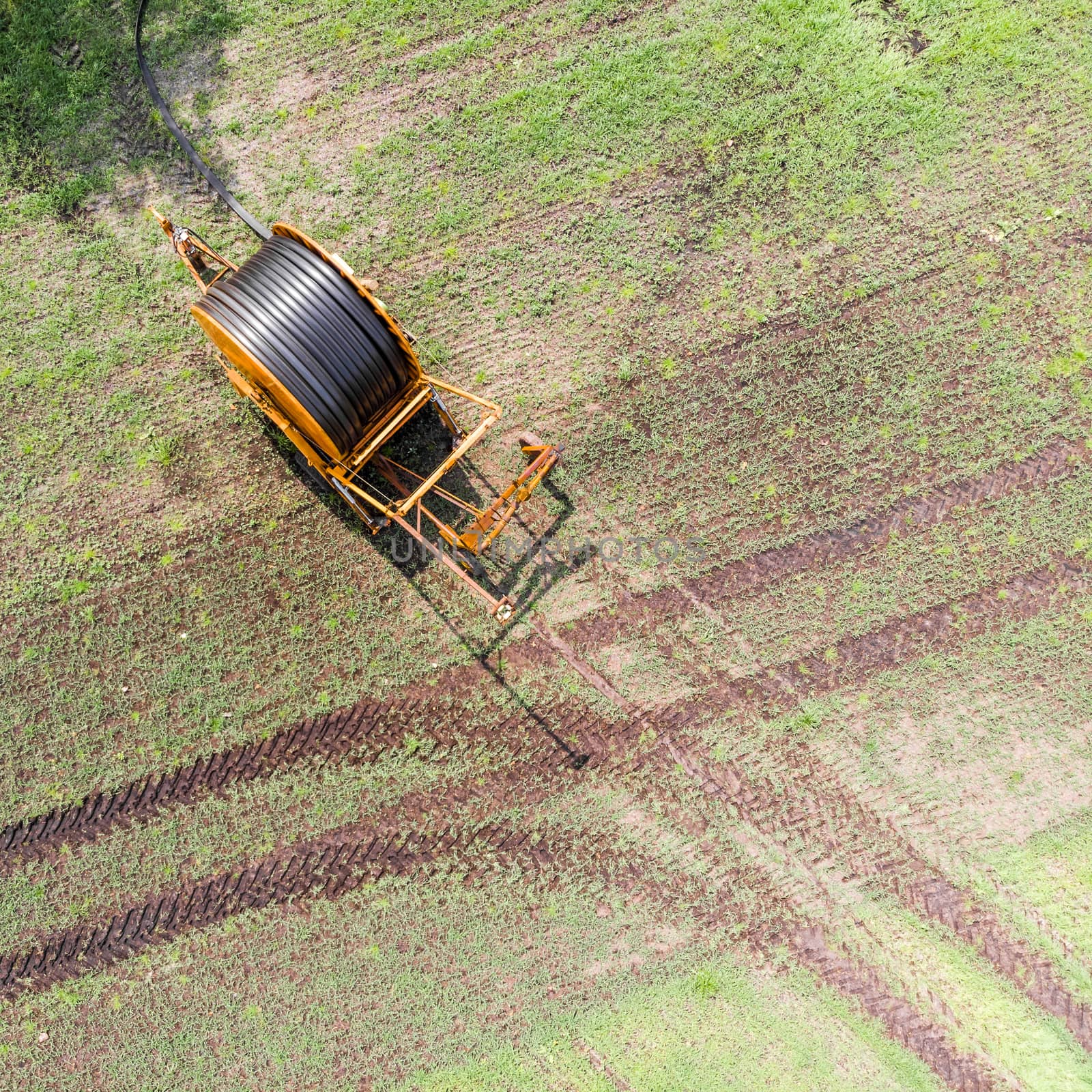 Aerial view of a huge hose cart used by the farmers to irrigate the arable land, Germany near Gifhorn by geogif