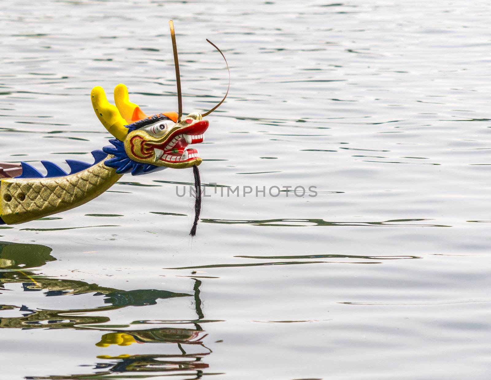 Colorful carved dragon head on the front part of a dragon boat at the dragon boat race in Hannover