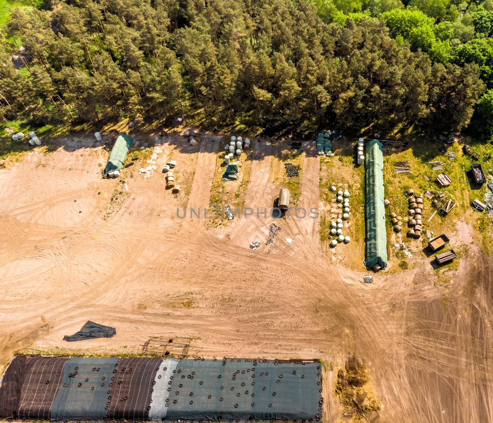 Detailed view from the air of a storage place for a farm, with silage, hay and straw, aerial view by geogif